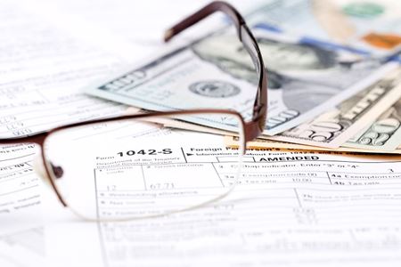 A pair of glasses sitting on a tax form