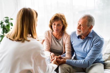 doctor counseling a patient and family member